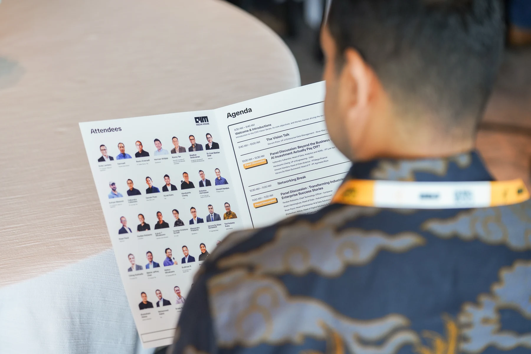 Participant reading event materials — CIO Vision Jakarta 2026